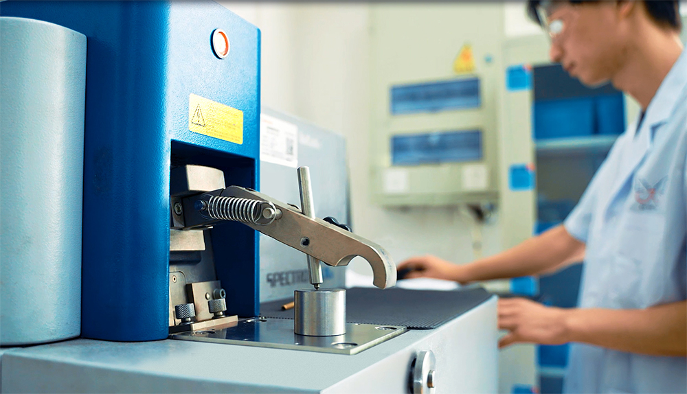 Worker operating machinery for precision manufacturing of fire brackets